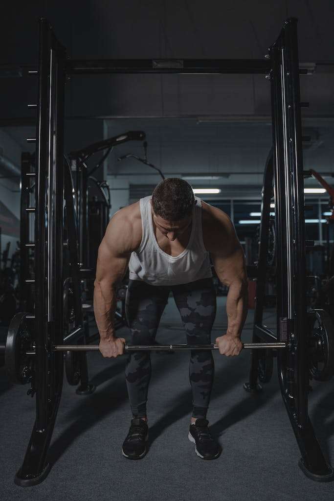 A Muscular Man Lifting a Barbell