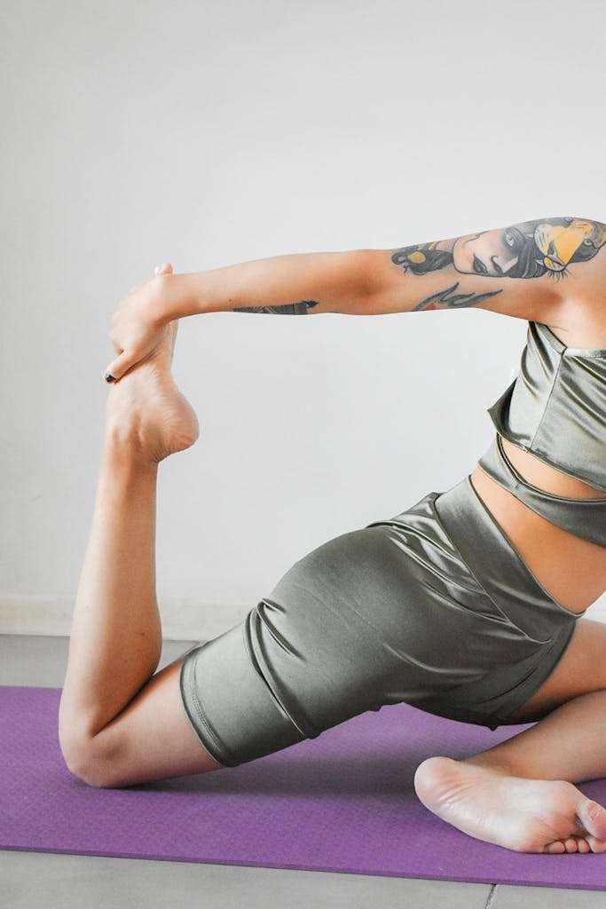 A woman in a green outfit doing yoga
