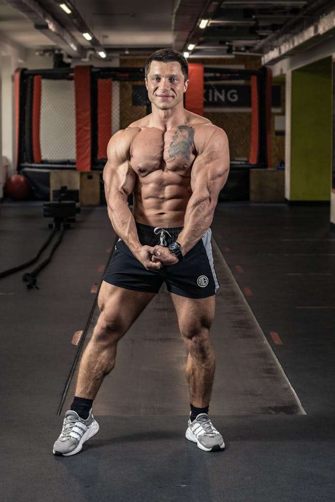 Man in Black Shorts Flexing Muscles