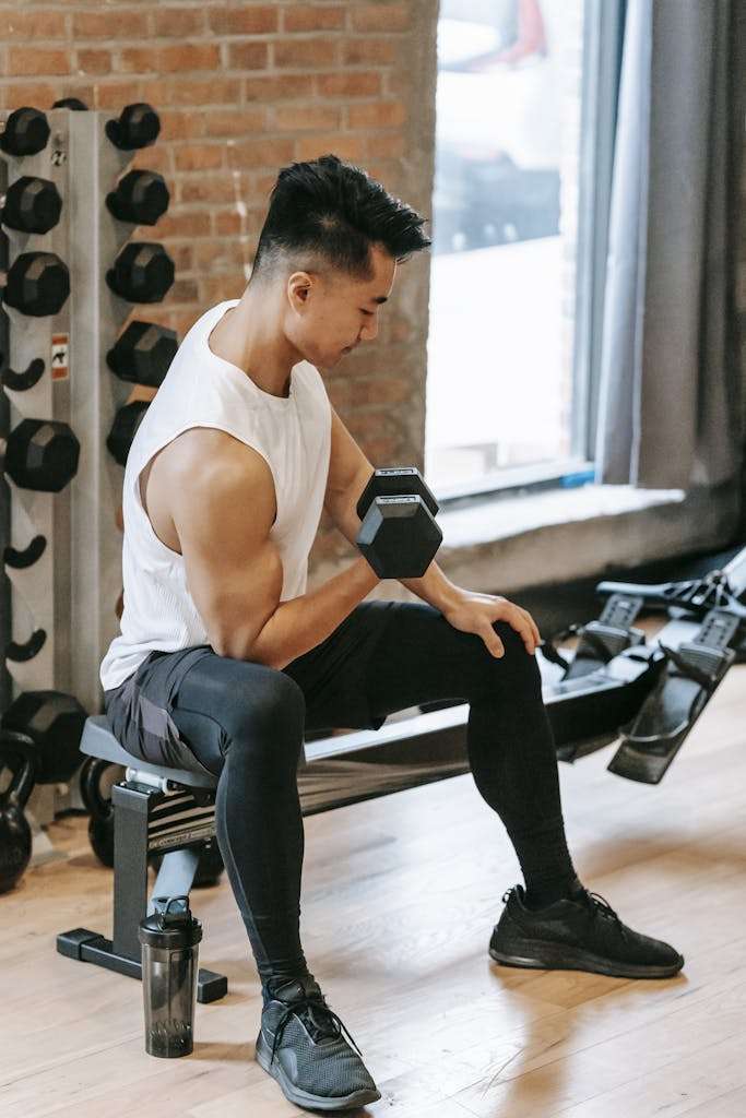 Muscular Asian man pumping bicep