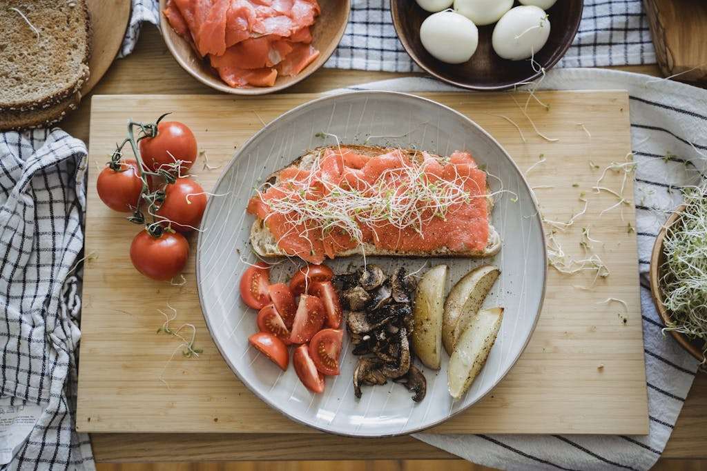 Sliced Fish on Bread and Vegetables on a Ceramic Plate